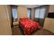 Bedroom with a red flower pattern bed cover and a dresser at 7704 Classy Cashmere Ct, Las Vegas, NV 89149