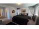 Bedroom with carpet, queen bed, and two city landscape pictures at 7704 Classy Cashmere Ct, Las Vegas, NV 89149