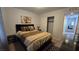 Comfortable bedroom with a padded headboard and closet space next to the door at 7704 Classy Cashmere Ct, Las Vegas, NV 89149