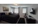 Bedroom boasts a large bed, dresser, and two windows at 7704 Classy Cashmere Ct, Las Vegas, NV 89149