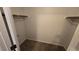 Empty walk-in closet with carpeting and closet rod ready for storage at 7704 Classy Cashmere Ct, Las Vegas, NV 89149