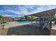 Inviting community pool with lounge chairs and shade structures for relaxation at 7704 Classy Cashmere Ct, Las Vegas, NV 89149