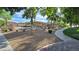 Community pool surrounded by lush landscaping and shade trees at 7704 Classy Cashmere Ct, Las Vegas, NV 89149