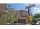 Exterior view of a two-story home with a private garage on a sunny day at 7704 Classy Cashmere Ct, Las Vegas, NV 89149