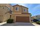 Two-story home featuring a two car garage and desert landscaping at 7704 Classy Cashmere Ct, Las Vegas, NV 89149