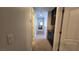 Neutral-toned hallway featuring cabinetry and doors leading to various rooms at 7704 Classy Cashmere Ct, Las Vegas, NV 89149