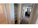 Hallway closet with white shelves leads into a bedroom with black comforter at 7704 Classy Cashmere Ct, Las Vegas, NV 89149