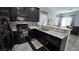 Bright kitchen featuring stainless steel appliances, granite counters, and dark cabinets at 7704 Classy Cashmere Ct, Las Vegas, NV 89149