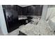 Well-equipped kitchen boasting dark cabinets, granite countertops, and stainless steel appliances at 7704 Classy Cashmere Ct, Las Vegas, NV 89149
