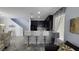 Modern kitchen showcases dark cabinetry, granite countertops, and stylish bar stool seating at 7704 Classy Cashmere Ct, Las Vegas, NV 89149