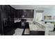 Charming kitchen with stainless steel appliances, dark cabinetry, and bar stool seating at 7704 Classy Cashmere Ct, Las Vegas, NV 89149