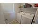 Functional laundry room with a washer, dryer, storage, and natural light at 7704 Classy Cashmere Ct, Las Vegas, NV 89149