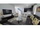 Inviting living room featuring tile floors, comfortable seating, and a sleek entertainment center at 7704 Classy Cashmere Ct, Las Vegas, NV 89149
