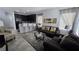 Open-concept living room with bar seating connecting to the kitchen area at 7704 Classy Cashmere Ct, Las Vegas, NV 89149