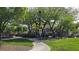Community playground with swings and climbing structures nestled among mature trees at 7704 Classy Cashmere Ct, Las Vegas, NV 89149