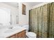 Clean bathroom with a white sink, toilet, and a shower with a decorative shower curtain at 7724 Somerhill Point Way, Las Vegas, NV 89139
