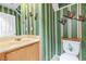 Unique bathroom with striped wallpaper, wooden accents, and modern fixtures at 7724 Somerhill Point Way, Las Vegas, NV 89139