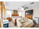 Cozy bedroom featuring a comfortable couch, large bed, dresser, and TV at 7724 Somerhill Point Way, Las Vegas, NV 89139