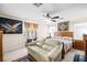 Comfortable bedroom with large bed, couch, ceiling fan, and decorative furnishings at 7724 Somerhill Point Way, Las Vegas, NV 89139