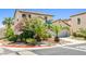 Lovely home exterior with desert landscaping, lush green shrubs, and a two-car garage at 7724 Somerhill Point Way, Las Vegas, NV 89139