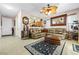 Open-concept living room with tile floors, plush seating, and decorative accents at 7724 Somerhill Point Way, Las Vegas, NV 89139
