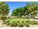 Neighborhood park featuring a green lawn, mature trees, and inviting benches at 7724 Somerhill Point Way, Las Vegas, NV 89139