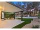 Backyard featuring a covered patio, green artificial turf, and landscaped area with gravel accents at 9029 Rivers Edge Dr, Las Vegas, NV 89117