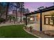 Backyard featuring covered patio, landscaped yard, and lush green artificial turf at 9029 Rivers Edge Dr, Las Vegas, NV 89117