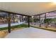 Covered backyard patio with modern design, landscaped yard, and turf at 9029 Rivers Edge Dr, Las Vegas, NV 89117