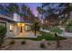 Backyard view featuring a covered patio with outdoor lighting and landscaped yard at 9029 Rivers Edge Dr, Las Vegas, NV 89117