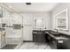 Modern bathroom with glass shower, marble walls, and sleek black double vanity at 9029 Rivers Edge Dr, Las Vegas, NV 89117