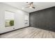 A well-lit bedroom with wood floors, and modern wall accents at 9029 Rivers Edge Dr, Las Vegas, NV 89117