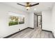 Bedroom featuring wood floors and view to laundry room and backyard at 9029 Rivers Edge Dr, Las Vegas, NV 89117