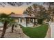 Charming single-story home with a tiled roof, manicured landscaping, and an inviting outdoor living space at 9029 Rivers Edge Dr, Las Vegas, NV 89117