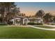 Charming single-story home with lush, green landscaping and a two-car garage on a sunny day at 9029 Rivers Edge Dr, Las Vegas, NV 89117
