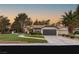 Beautiful single-story home with a two-car garage, lush lawn and desert landscaping at 9029 Rivers Edge Dr, Las Vegas, NV 89117