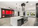 Gourmet kitchen features a sleek island with stainless steel appliances and a modern vent hood at 9029 Rivers Edge Dr, Las Vegas, NV 89117
