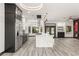 Modern kitchen with marble waterfall island, stainless appliances, and an open layout at 9029 Rivers Edge Dr, Las Vegas, NV 89117