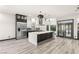 Bright, open kitchen boasts a waterfall island, stainless steel appliances, and modern finishes at 9029 Rivers Edge Dr, Las Vegas, NV 89117