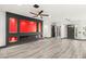 Bright living room with modern gray floors, a fireplace accent wall, and views of the front entrance at 9029 Rivers Edge Dr, Las Vegas, NV 89117