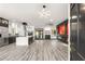 Modern living room with sleek floors, a fireplace, and a stylish kitchen with stainless appliances at 9029 Rivers Edge Dr, Las Vegas, NV 89117