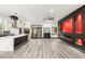 Open-concept living room with a fireplace, modern floors, and an open kitchen for entertaining at 9029 Rivers Edge Dr, Las Vegas, NV 89117