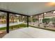Covered patio offering a view of the landscaped backyard, featuring turf, gravel, mature trees, and privacy fencing at 9029 Rivers Edge Dr, Las Vegas, NV 89117