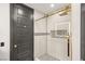 Modern shower with black accents, gray door and gold hardware at 9029 Rivers Edge Dr, Las Vegas, NV 89117