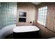 Elegant bathroom features a standalone tub with dark fixtures and stylish glass block accents at 912 Pro Players Dr, Las Vegas, NV 89134