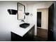 Bathroom featuring a black sink, modern fixtures, and a decorative mirror at 912 Pro Players Dr, Las Vegas, NV 89134