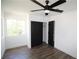 A bright bedroom with hard floors, large window, closet and ceiling fan at 912 Pro Players Dr, Las Vegas, NV 89134