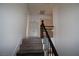 Well-lit hallway with modern black iron railing and light walls, connecting different areas of the home at 912 Pro Players Dr, Las Vegas, NV 89134