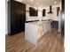 Kitchen with an island, stainless steel appliances, custom cabinets and stone countertops at 912 Pro Players Dr, Las Vegas, NV 89134