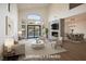 Staged living room with floor-to-ceiling fireplace, tall windows, and open floor plan at 912 Pro Players Dr, Las Vegas, NV 89134